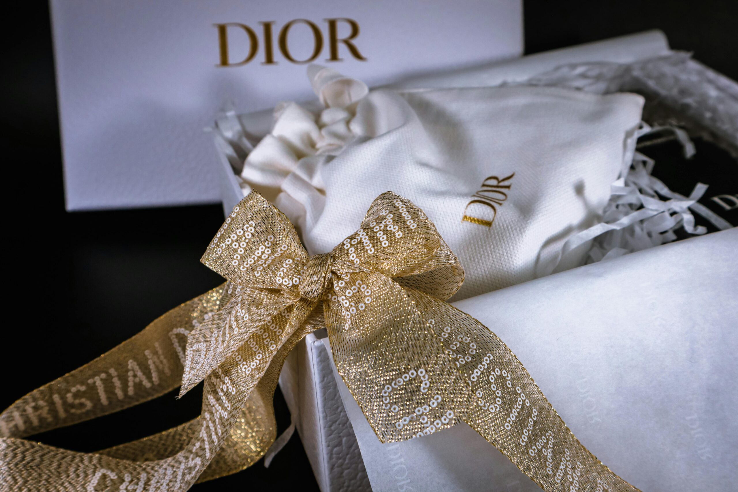 Luxurious Dior gift box featuring a golden sequin ribbon, exuding elegance and style.